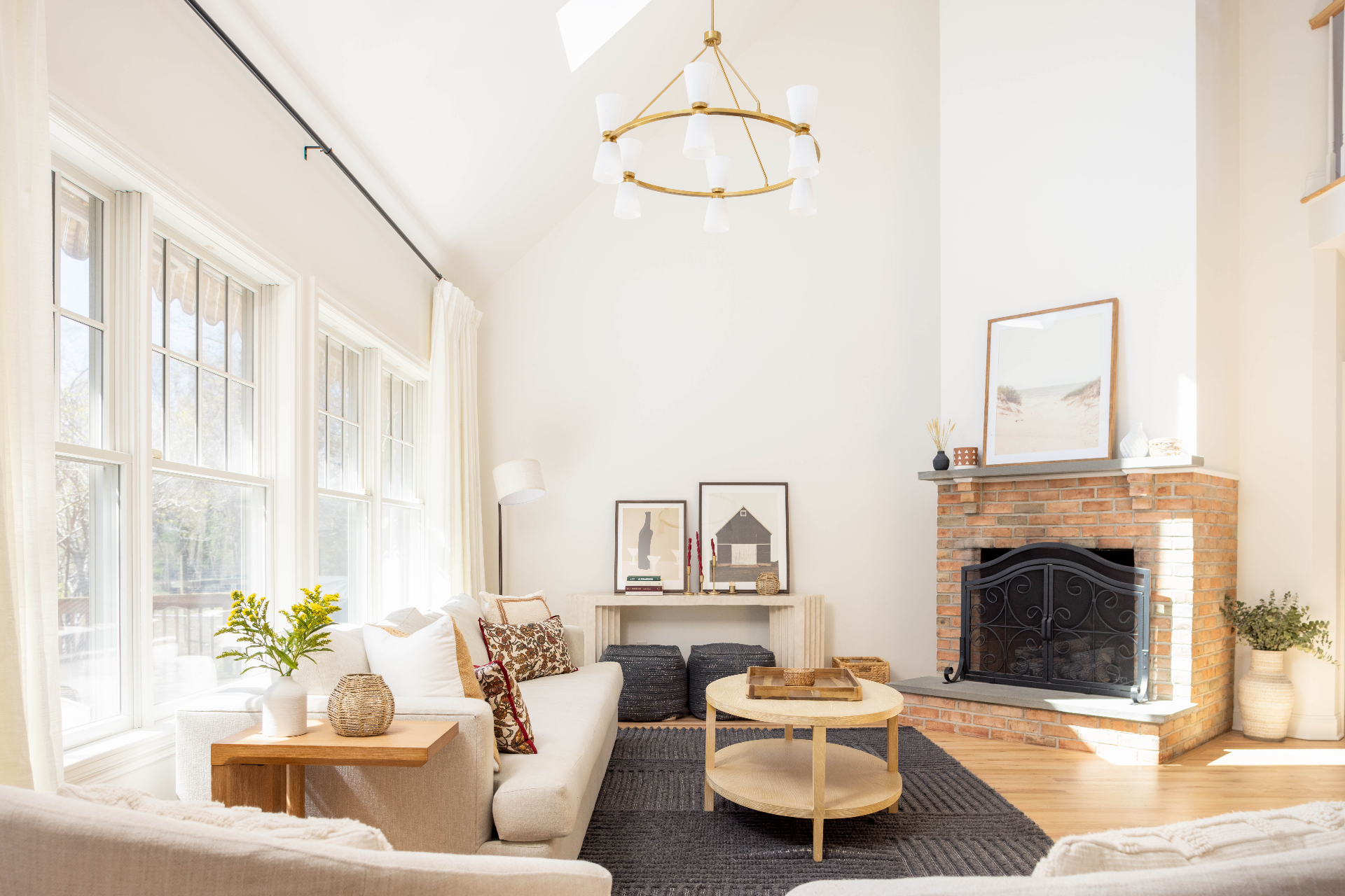 Living room with vaulted ceilings, brick fireplace and chandelier